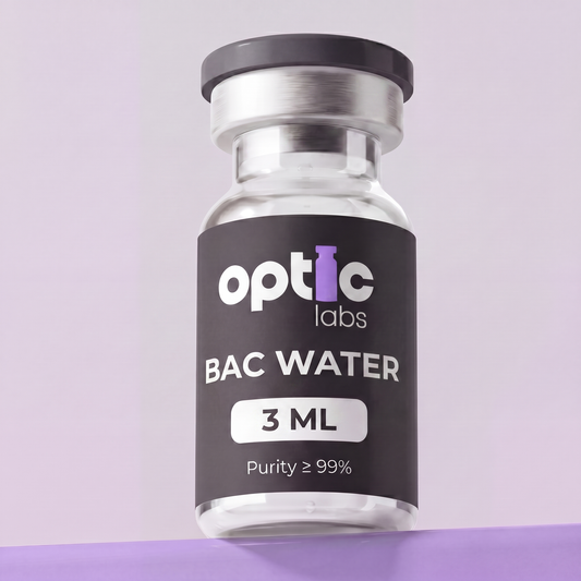A clear Optic Labs BAC Water 3ml vial (Purity ≥99%) stands upright before a pastel purple backdrop, showcasing its role as premium Australian peptide diluent. Optic Labs Au